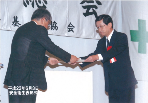 八幡労働基準協会清水会長より表彰されるNSES岡崎部長